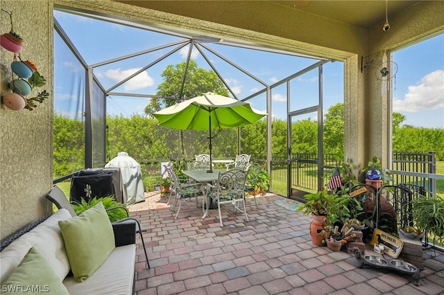 view of patio / terrace featuring a lanai, grilling area, and an outdoor living space