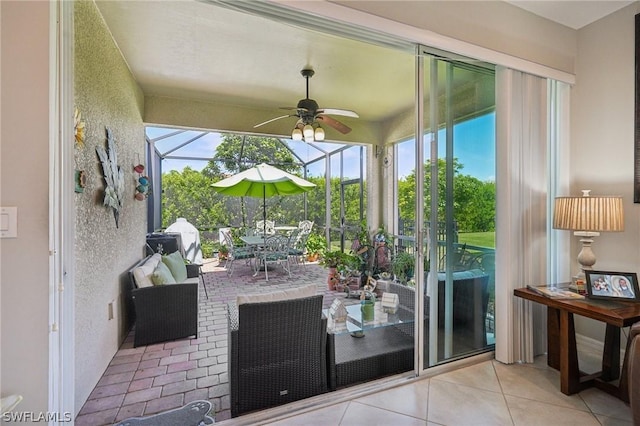 sunroom / solarium featuring ceiling fan