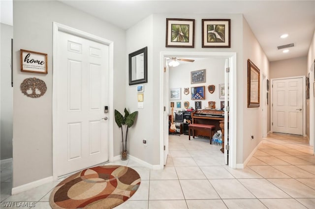 entryway with light tile patterned floors and ceiling fan