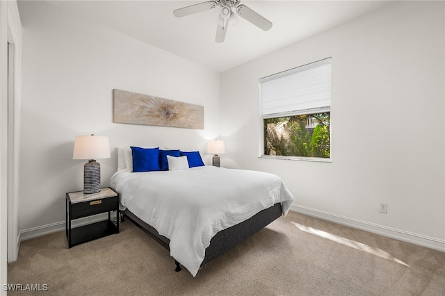 bedroom featuring ceiling fan and light carpet