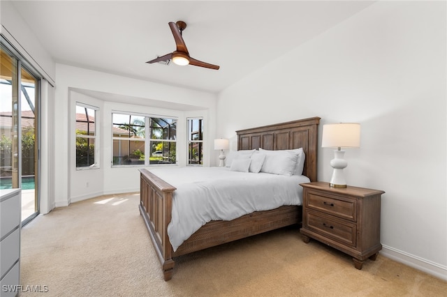 bedroom with ceiling fan, light colored carpet, and access to exterior