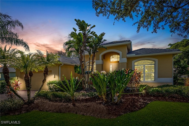 view of front of house with a yard and a garage