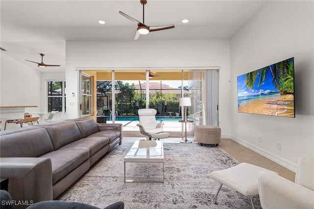 tiled living room with ceiling fan and a wealth of natural light