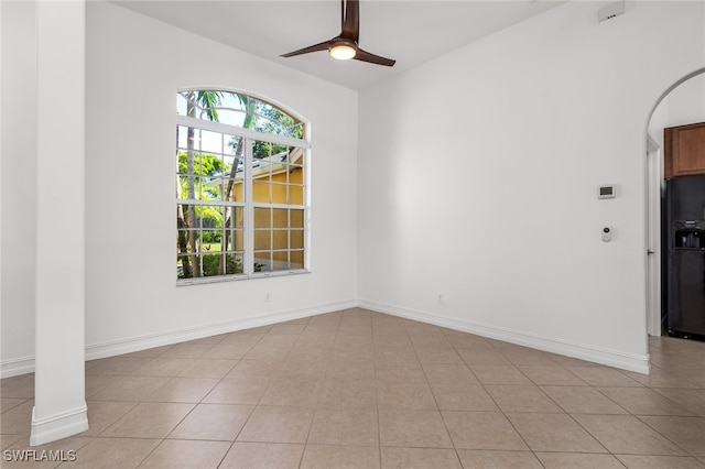 tiled spare room with ceiling fan, lofted ceiling, and ornate columns