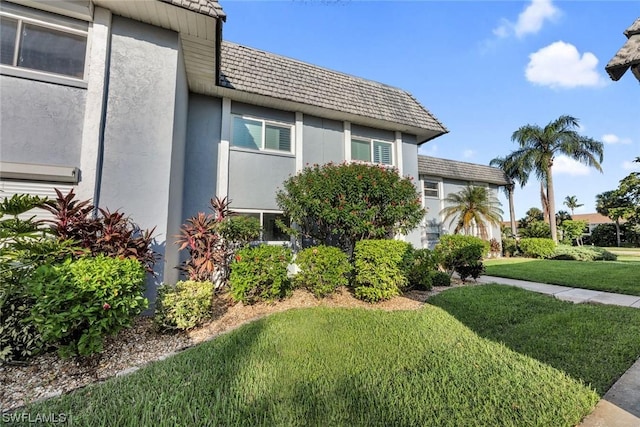 view of side of home with a lawn