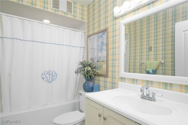 full bathroom featuring vanity, shower / tub combo, and toilet