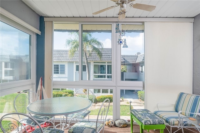 sunroom featuring ceiling fan