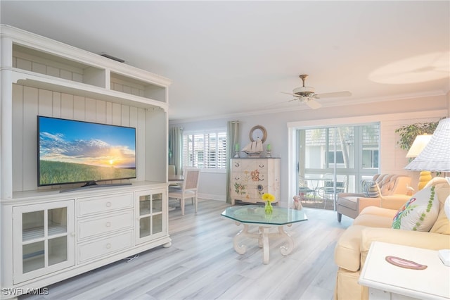 living room featuring crown molding, ceiling fan, and light hardwood / wood-style floors