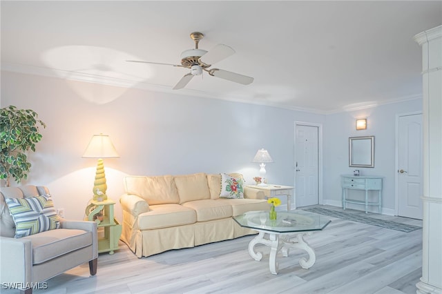 living room with crown molding, light hardwood / wood-style floors, and ceiling fan