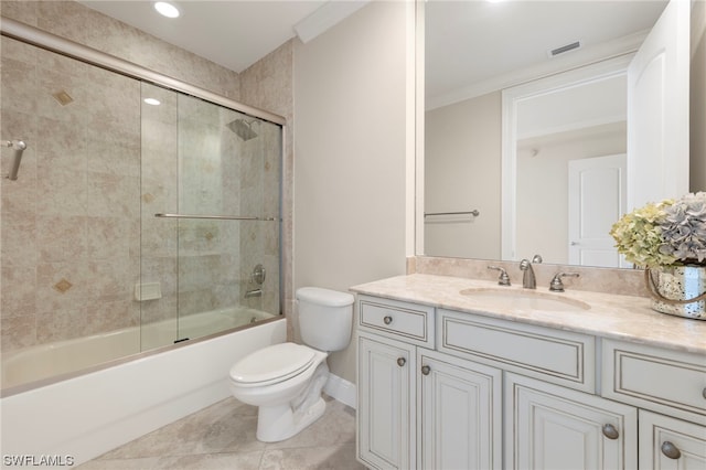 full bathroom with combined bath / shower with glass door, toilet, tile floors, and large vanity