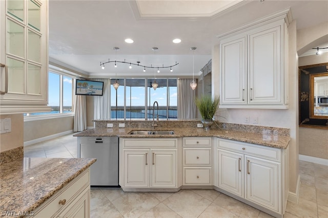 kitchen featuring pendant lighting, light stone counters, appliances with stainless steel finishes, and sink