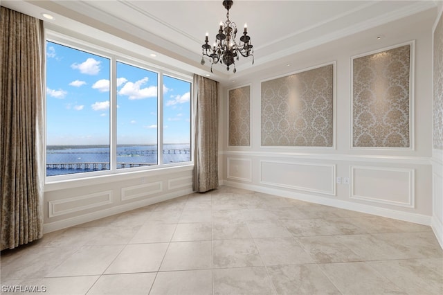 tiled spare room with a water view and a notable chandelier