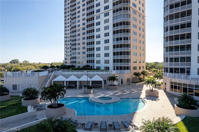 view of pool with a community hot tub and a patio area