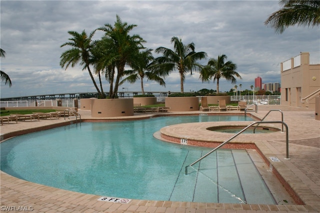 view of swimming pool with a community hot tub and a patio