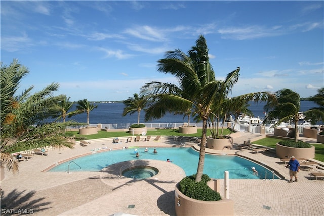 view of swimming pool featuring a patio and a hot tub