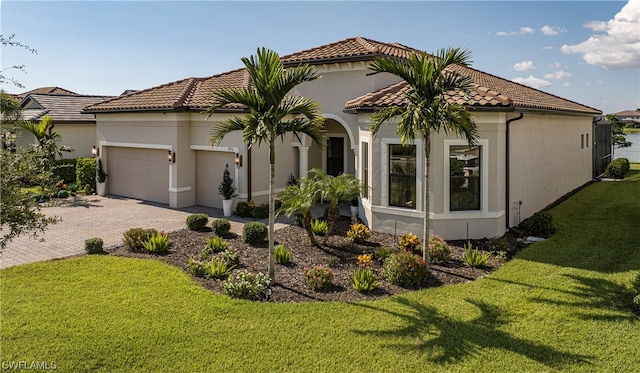 view of front of house featuring a front yard and a garage