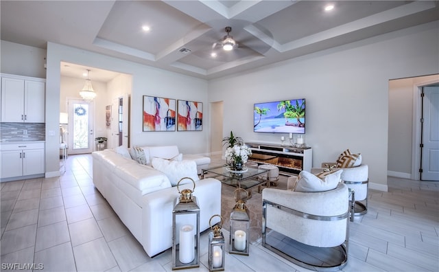 living room with coffered ceiling, light tile floors, ceiling fan, and beam ceiling