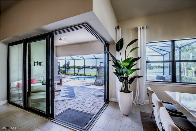 entryway with a water view and light hardwood / wood-style floors