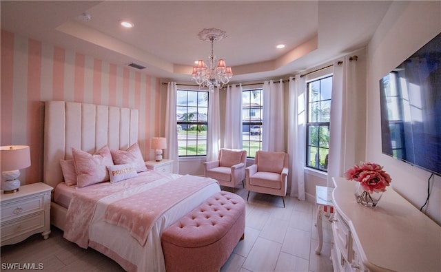 bedroom with a notable chandelier and a raised ceiling