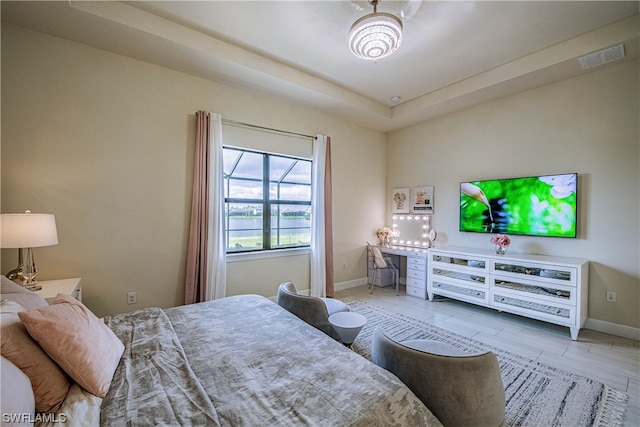 bedroom featuring a raised ceiling