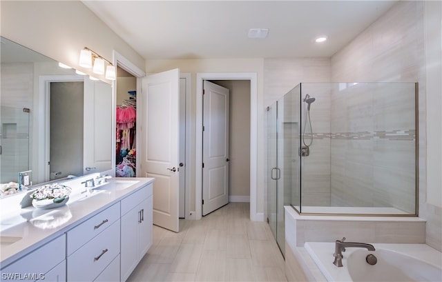 bathroom with double vanity, separate shower and tub, and tile flooring