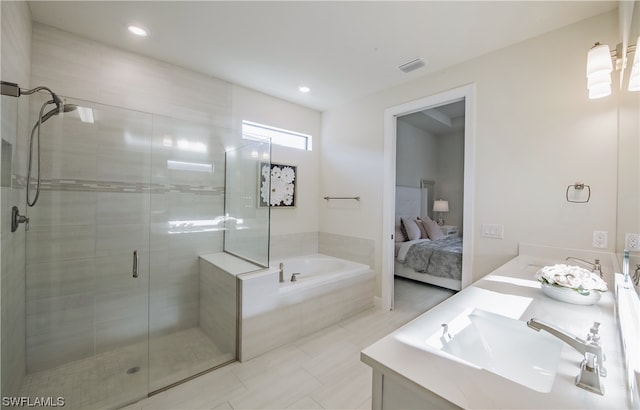 bathroom featuring tile floors, dual bowl vanity, and separate shower and tub