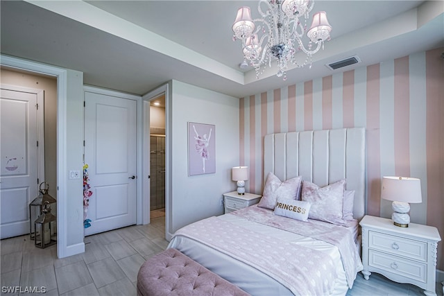 bedroom with a raised ceiling and an inviting chandelier