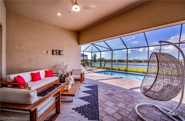 exterior space with a water view, a patio, an outdoor living space, and glass enclosure