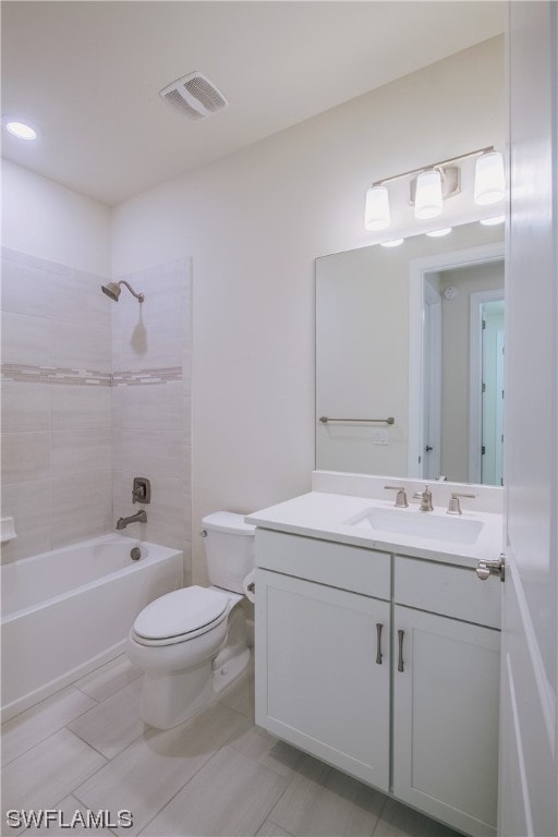 full bathroom featuring tile floors, toilet, vanity, and tiled shower / bath