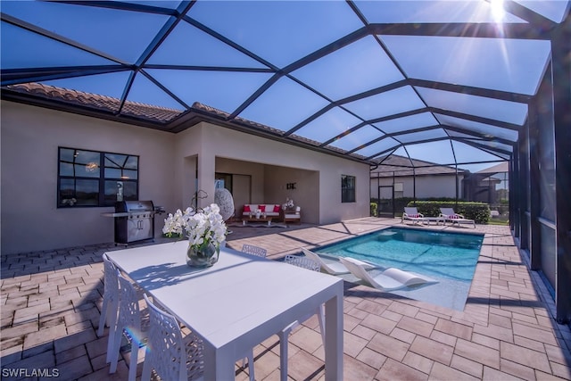 view of swimming pool with area for grilling, a lanai, and a patio area