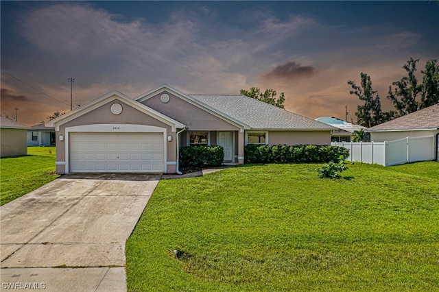 single story home featuring a yard and a garage