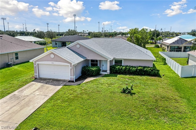 ranch-style home featuring a garage, a front lawn, and central air condition unit