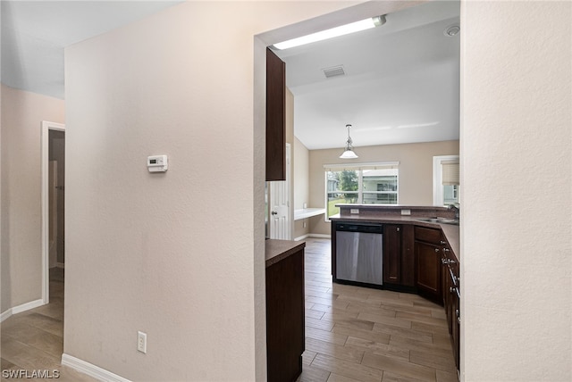 kitchen with dark brown cabinets, stainless steel dishwasher, decorative light fixtures, and sink