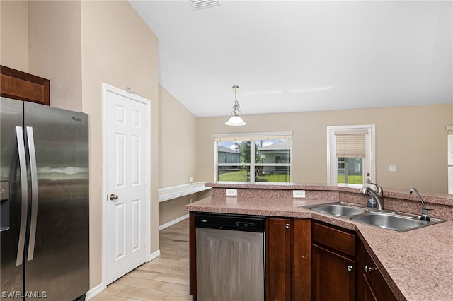 kitchen with appliances with stainless steel finishes, dark brown cabinetry, decorative light fixtures, and sink