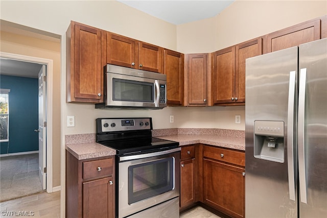 kitchen featuring light hardwood / wood-style floors and appliances with stainless steel finishes