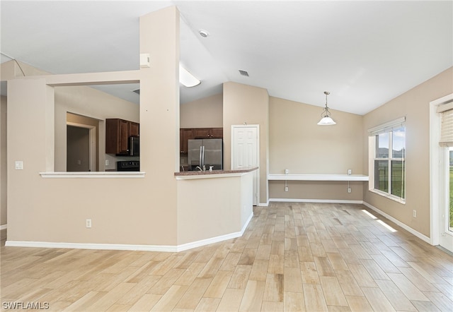 unfurnished living room with vaulted ceiling