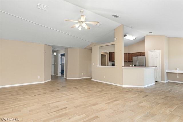 unfurnished living room featuring light wood-type flooring, ceiling fan, and lofted ceiling