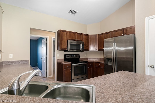 kitchen with dark brown cabinetry, sink, and appliances with stainless steel finishes