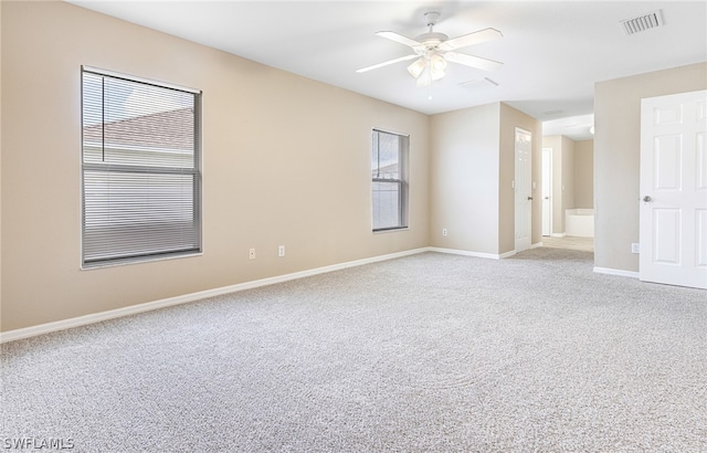 spare room featuring ceiling fan and light carpet