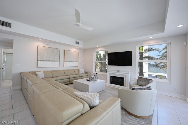 living room with ceiling fan and light tile floors