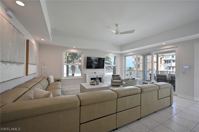 tiled living room with ceiling fan