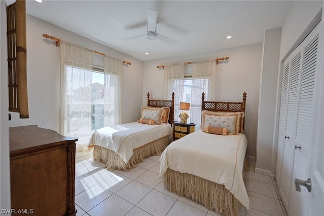 tiled bedroom with a closet and ceiling fan