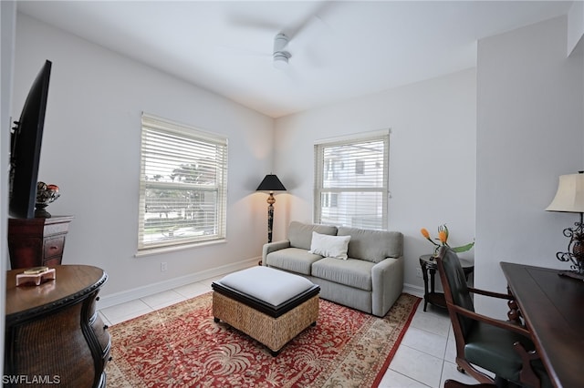 tiled living room with plenty of natural light and ceiling fan