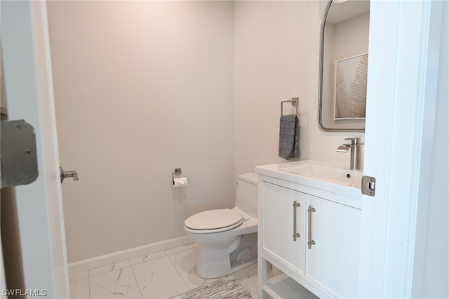 bathroom with toilet, tile flooring, and vanity