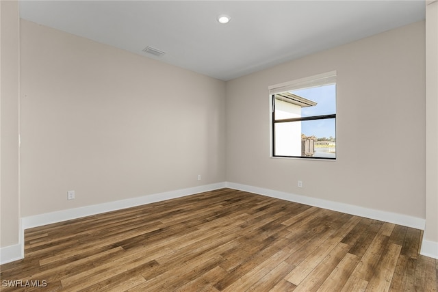 empty room with wood-type flooring