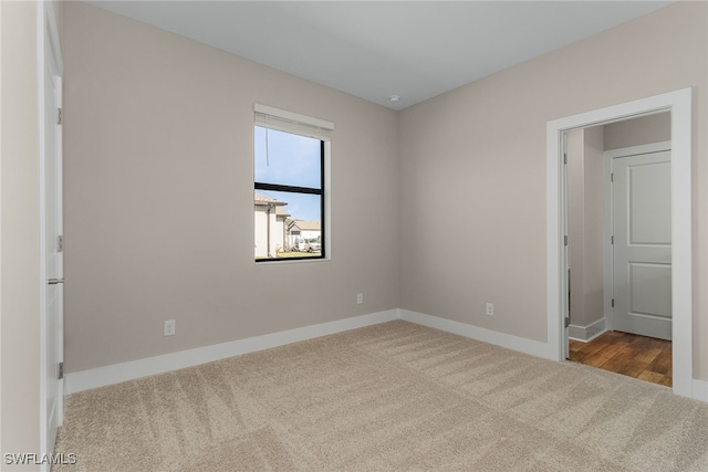 unfurnished bedroom featuring light carpet