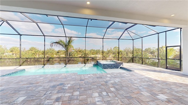 view of pool with glass enclosure, an in ground hot tub, and pool water feature