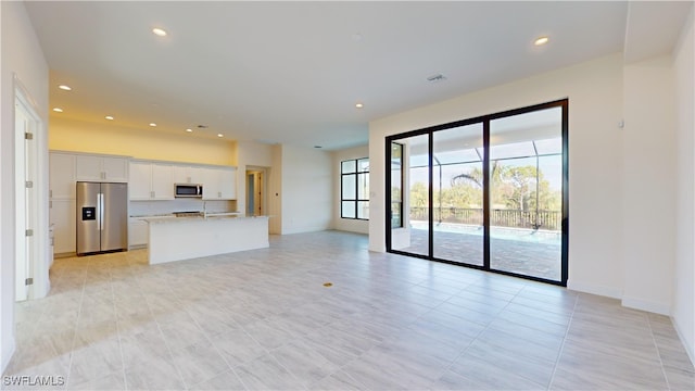 unfurnished living room featuring light tile patterned floors