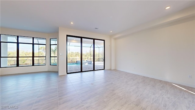 spare room featuring light tile patterned flooring