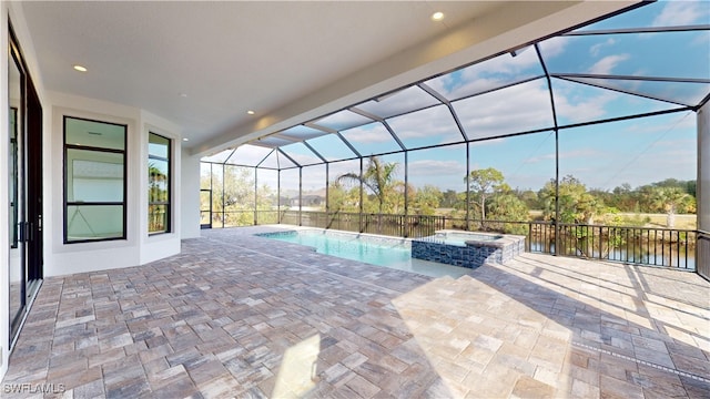 exterior space featuring an in ground hot tub, a patio, a water view, and a lanai